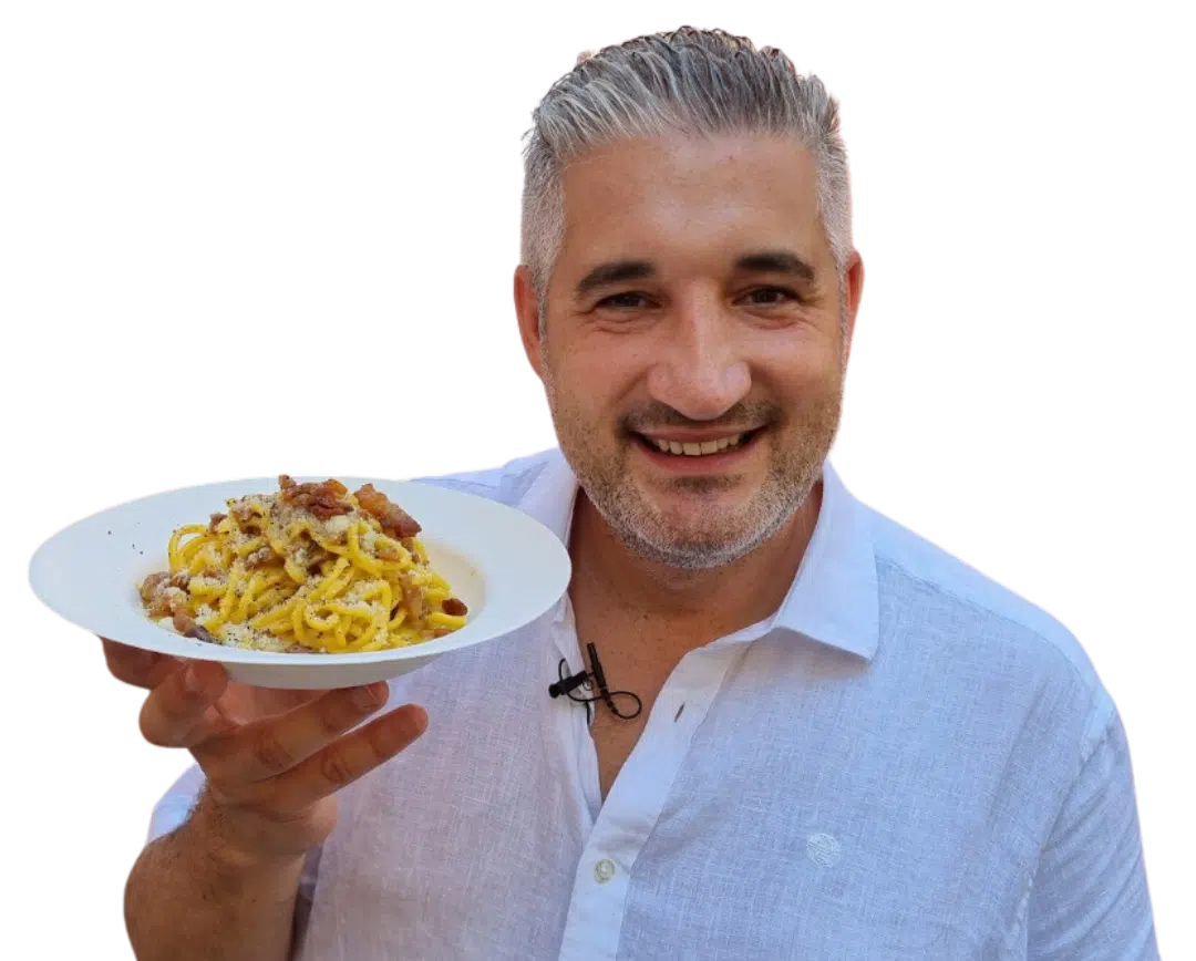 Chef Vincenzo holding a plate of delicious carbonara