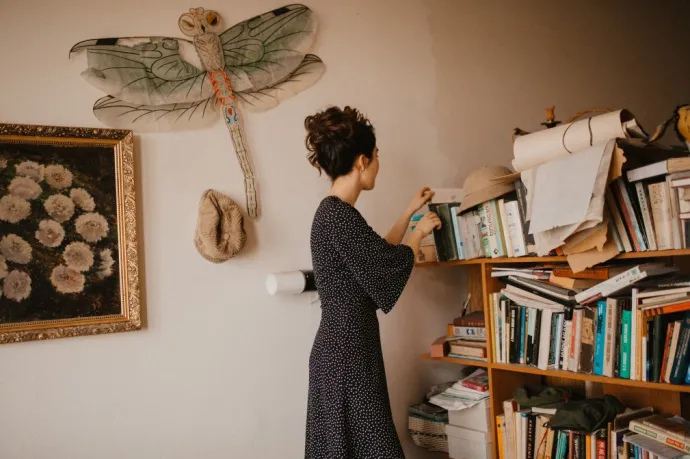 reading books on bookshelf as self-care for a high achiever type